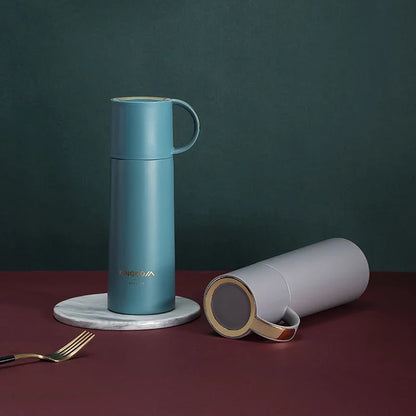 Blue thermos bottle with a white lid on a dark background