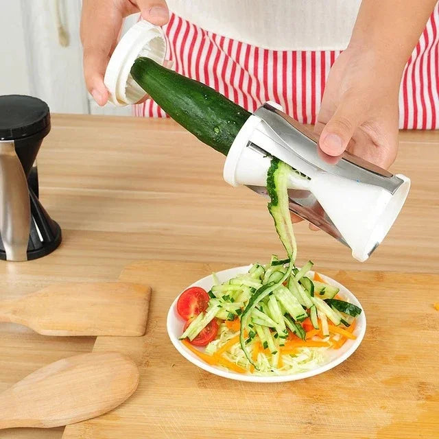 Person using a vegetable peeler to slice a cucumber over a plate of salad on a wooden table.