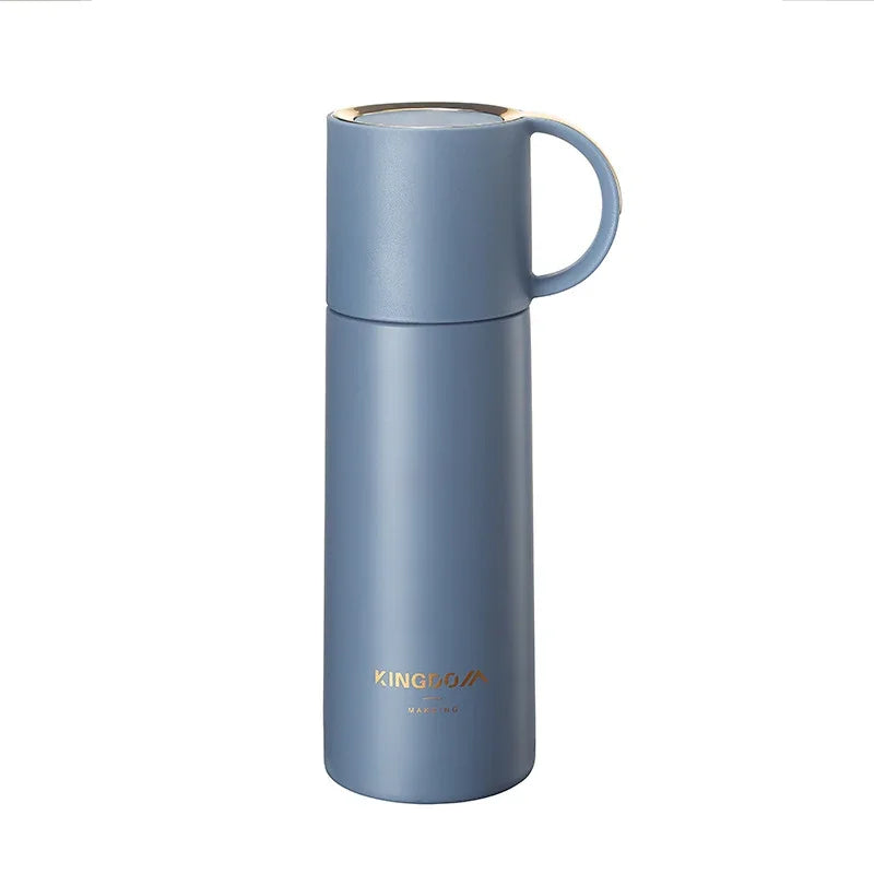 Blue thermos bottle with a gold lid on a white background