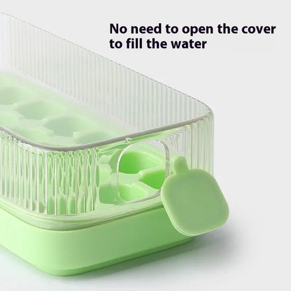 A light green silicone ice cube tray with a clear ribbed lid and a small matching silicone tab, shown on a white background with the text 'No need to open the cover to fill the water'.