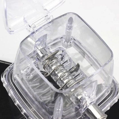 Close-up of a clear mechanical device with a spring inside, on a white background.
