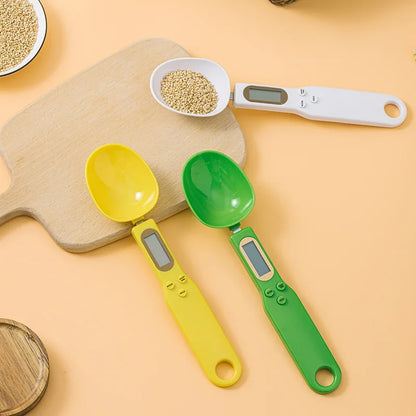 Two colorful digital measuring spoons on a yellow background with a bowl of grains.