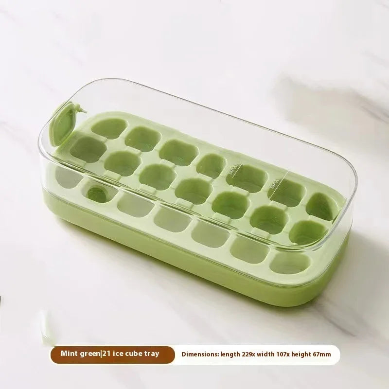 Mint green silicone ice cube tray with a clear plastic lid, shown on a light marble surface with a text overlay at the bottom detailing its dimensions.